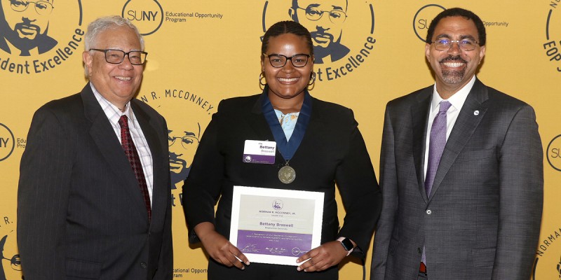 Bettany Braswell '23 was presented with the Norman R. McConney Jr. Award by SUNY Chancellor John B. King, Jr. (right) and Cesar Perales, vice chair of the SUNY Board of Trustees, April 17 in Albany, N.Y.
