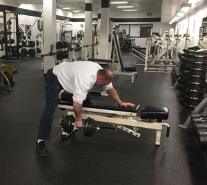 Bill Clark is training for his next Guinness World Book attempt: most one-armed dumbbell rows in a minute! Note that he must follow Guinness' rules regarding technique.