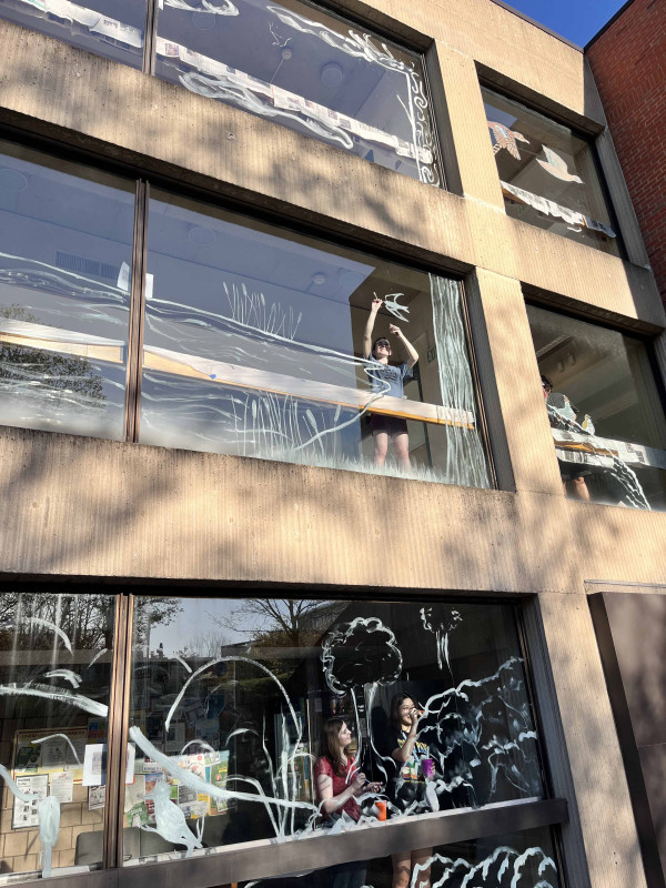 Binghamton University’s chapter of the Audubon Society paints a bird-themed mural on the Science Library's windows to prevent bird strikes.