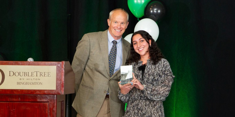 President Harvey Stenger presents Nora Monasheri with the Student of Distinction award at the Student Awards Gala on May 1, 2023.