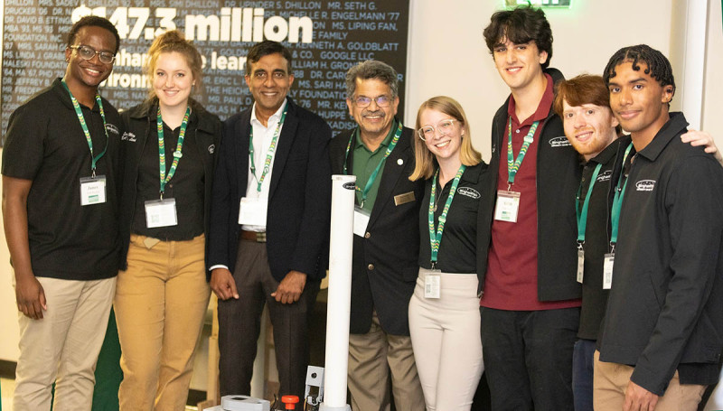 Subhachandra Chandra, MS ’95, and Watson College Dean Atul Kelkar meet with members of the Binghamton University Rover Team at Homecoming 2024.