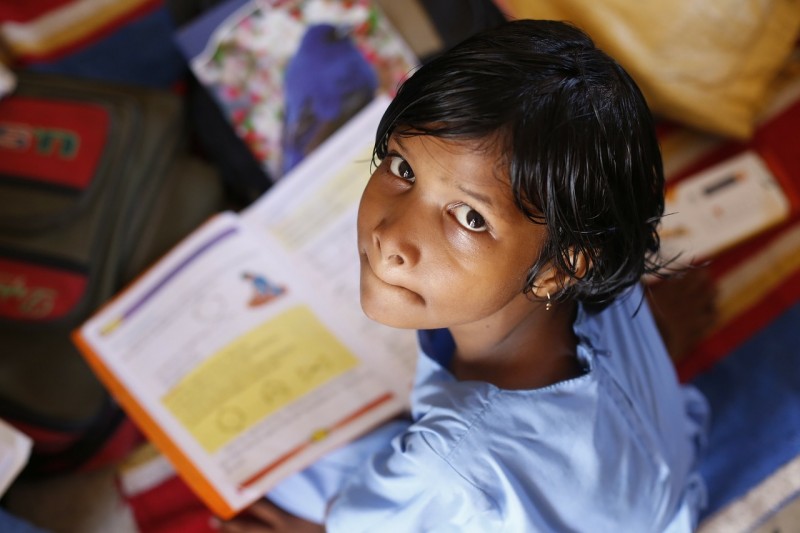 A young girl studying in India.