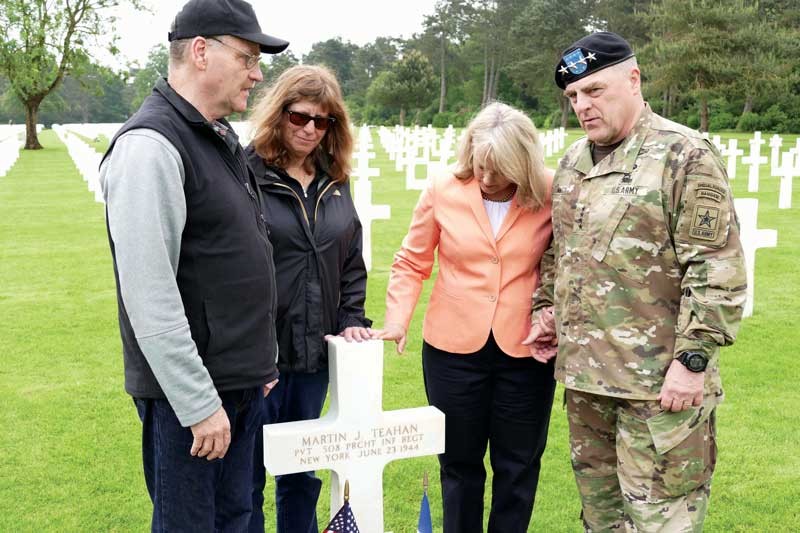 Jim and Monica Farrell and Holly and Gen. Mark Milley at Martin Teahan’s gravestone in the Normandy American Cemetery.