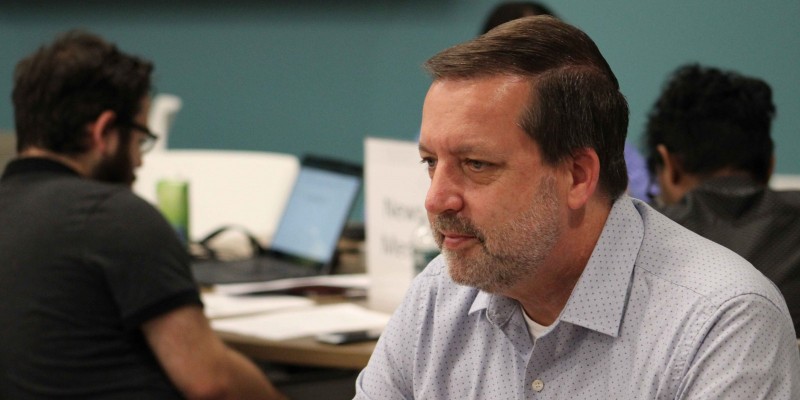 David Hubeny, the executive director for the Binghamton University Office of Emergency Management, working with his table of students during the simulation.