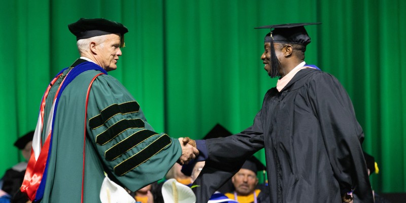 University President Harvey Stenger congratulated each graduating student as they crossed the stage during Decker College's Commencement ceremony on May 15.