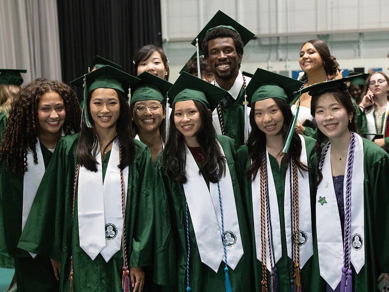 Undergraduate nursing students pose backstage before taking their seats in the Events Center.
