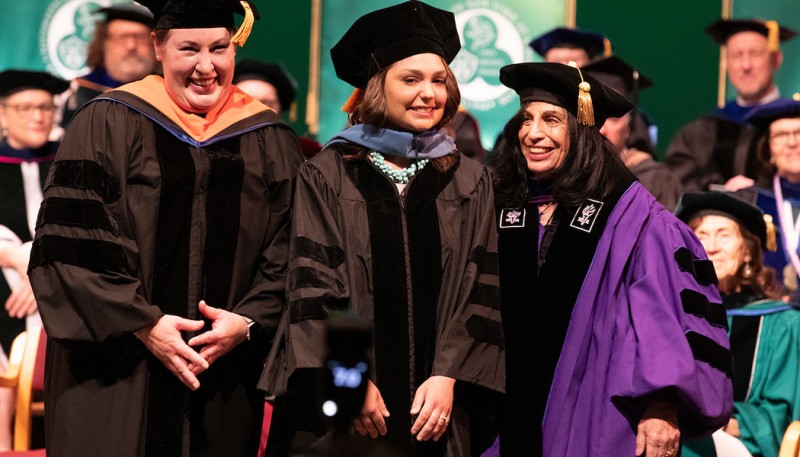 Gretchen Mahler, interim vice provost and dean of the Graduate School; Jess Evans, Doctor of Occupational Therapy candidate; and Jane Bear-Lehman, founding director of Decker's Division of Occupational Therapy, at the Doctoral Hooding Ceremony.