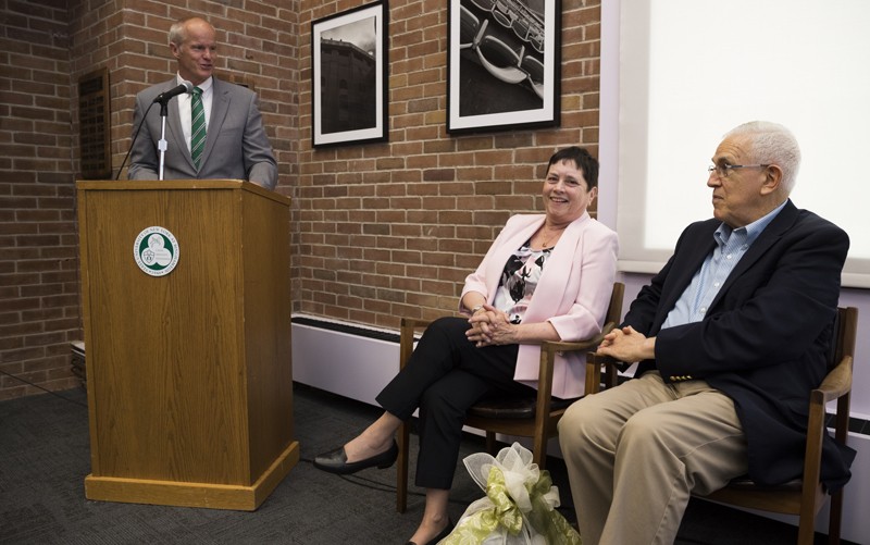 Binghamton University President Harvey Stenger salutes Randy and Ronald Ehrenberg in the conference room now named for the couple.