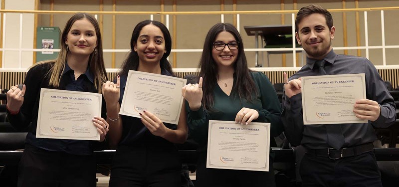 Seniors Mina Vanechanos, Mariam Rizk, Dimitra Pando, and Nicholas Palumbo show off their rings and certificates at the Order of the Engineer ceremony.