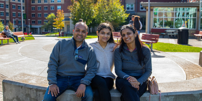 A student sits with family members in Newing College during Family Weekend 2025.
