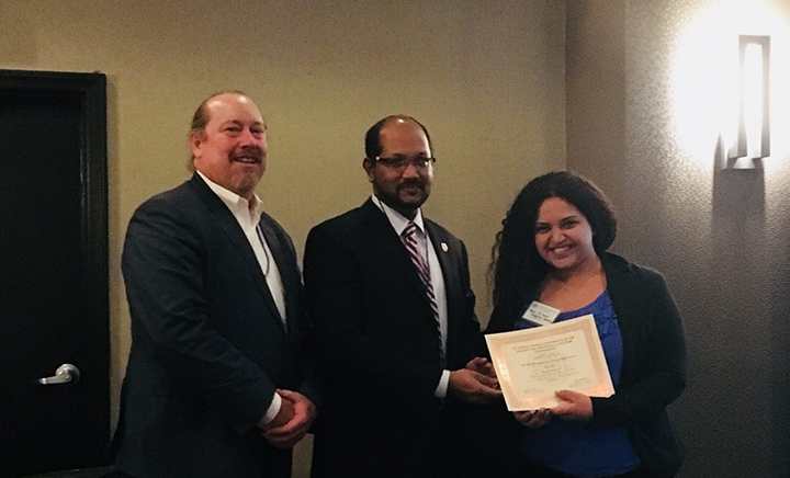 Hadir Elsayed (right) receiving her award from Anand Subramanian, the co-chair organizer of the SISE World Conference. On the left is professor Daryl L. Santos, Elsayed's advisor for the LSAMP research.