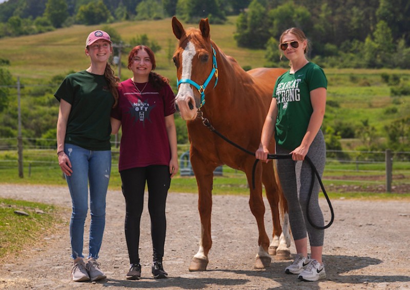 From left: Binghamton students Kylie Browning, Alessandra Antonacci and Emma Colling from Decker College’s speech and hearing science minor gain experience working with children (and horses) in the iTalk with Horses program.