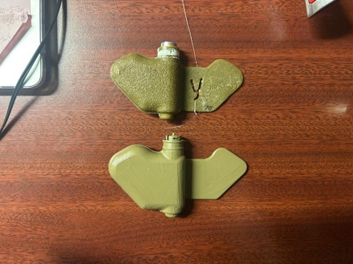 An inert PFM-1 mine and a plastic replica.