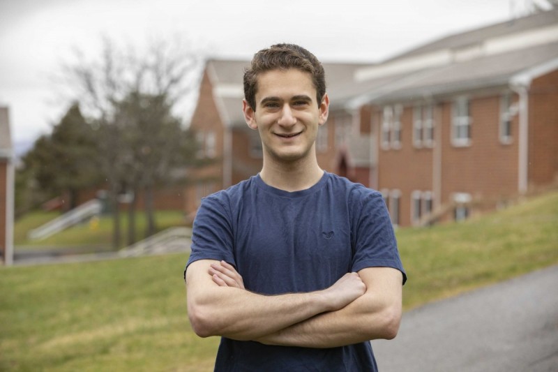 Jacob Goodman stands outside the Hillside Community, where he is currently residing on campus.