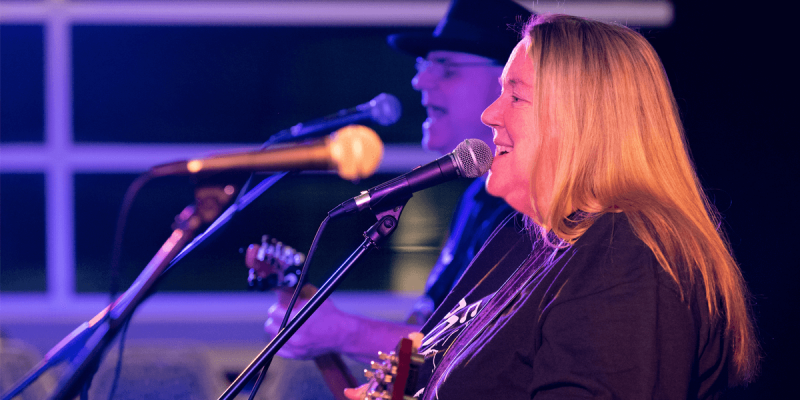 Dana Stewart, collegiate professor at Mountainview College, performs with her husband and bandmate Bob Rynone during a jam at Appalachian Dining Hall.