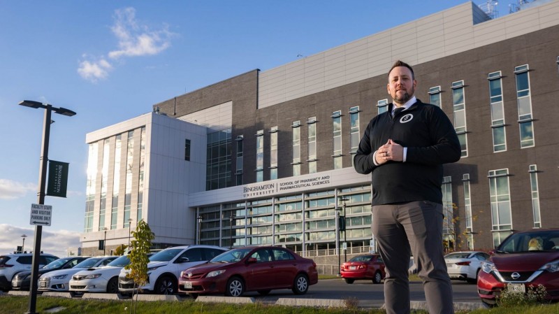 James “JJ” Brice, director of student affairs, in front of the School of Pharmacy and Pharmaceutical Sciences.