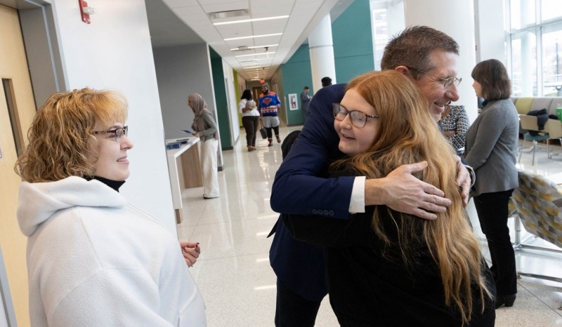 Program Director Kenneth McCall and Pharmacy Technician Program graduate Pecabo Scott hug following the graduation ceremony at the School of Pharmacy.