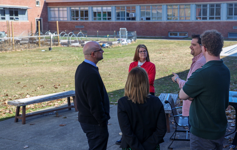 Martin Larocca, Binghamton's deputy chief sustainability officer, speaks with Sara Hall, senior assistant director of the Center for Civic Engagement; Matt Schaffer, executive director of civics and service initiatives for SUNY; Kelli Smith, assistant vice president for student success; and Andrew Clark, Empire State Service Corps coordinator, at the Three Sister's Garden in the Science 1 courtyard during Schaffer's visit to campus in March.