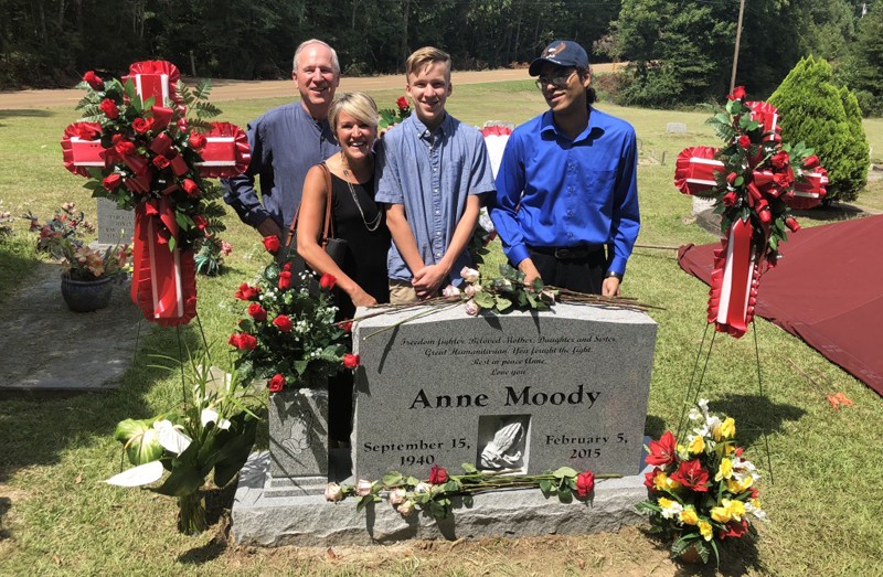 History Professor Leigh Ann Wheeler visits the gravesite of civil rights activist Anne Moody at Mount Pleasant Missionary Baptist Church Cemetery in Centreville, Miss. With Wheeler, from left, are her husband, Binghamton University Provost Donald Nieman, son Brady, and Sasha Straus, son of Anne Moody.