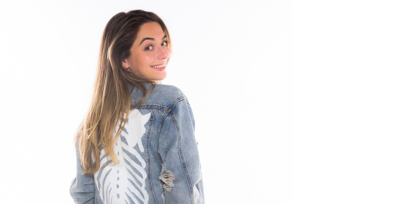 Rene Vorilas '21 wearing one of her hand-painted denim jackets