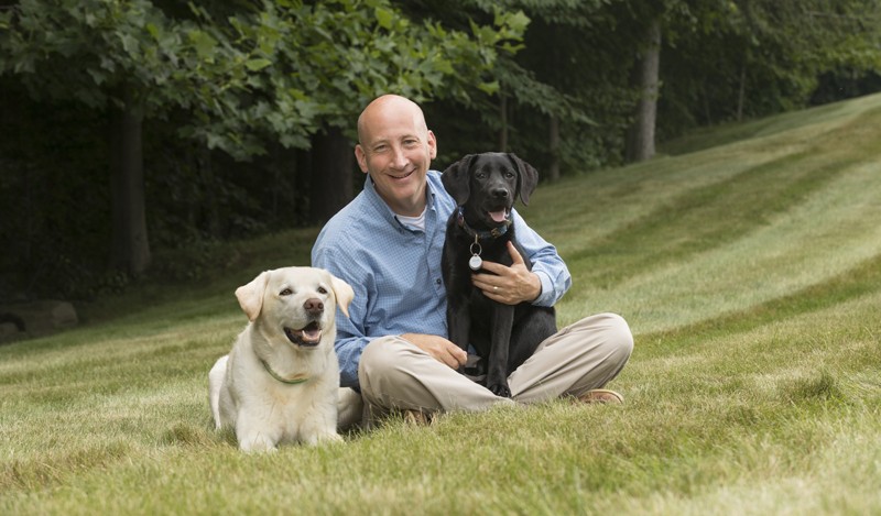 Dr. Jody Sandler '83 sits with Kermit, left, and Shiloh.