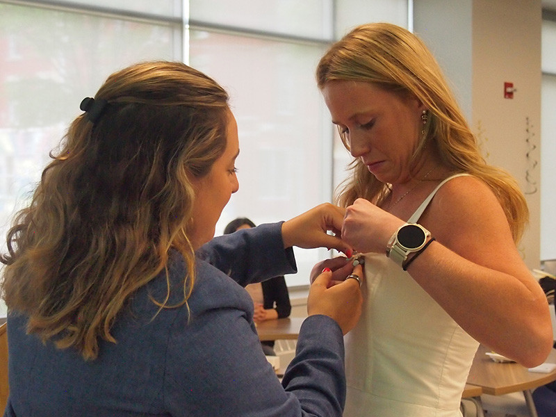 Twenty-six students made up the very first graduating class in Decker's master's program in speech and language pathology. Here, Interim Program Director and Assistant Professor Tia Spagnuolo pins student Shannon Strehle.