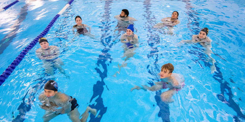 Students participate in a lifeguard certification class at the East Gym pool.