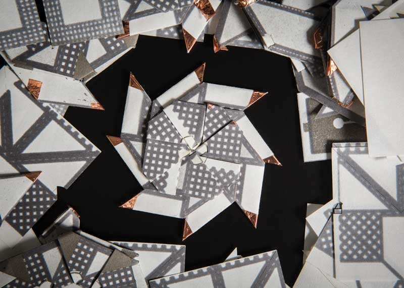 Different folding and stacking methods can significantly improve power and current outputs. This version of an origami battery is based on a ninja throwing star.