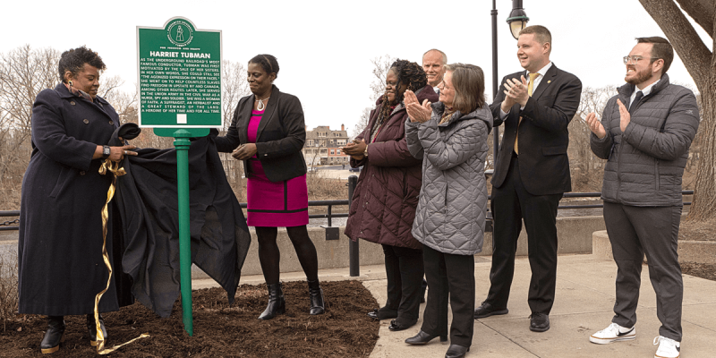 Sharon Bryant, associate director of the Tubman Center, and Anne Bailey, director of the Tubman Center, unveil the first historical marker in the Downtown Freedom Trail. With State Senator Lea Webb, President Harvey Stenger, Assemblywoman Donna Lupardo and Binghamton Mayor Jared Kraham.