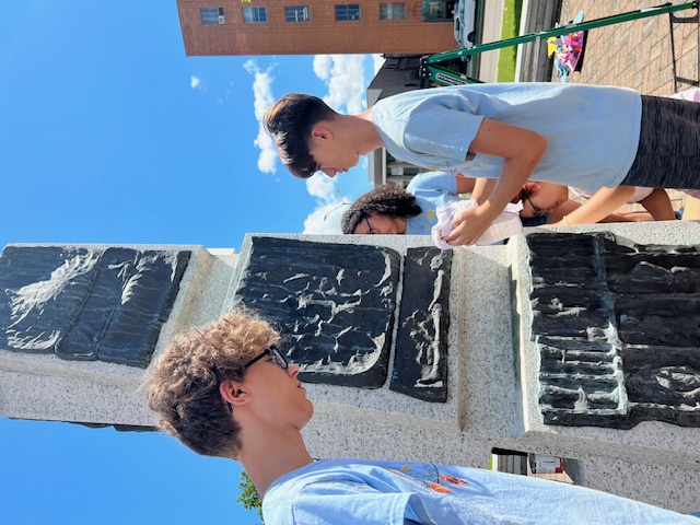 Volunteers from VINES work on the Wilson statue in downtown Binghamton.