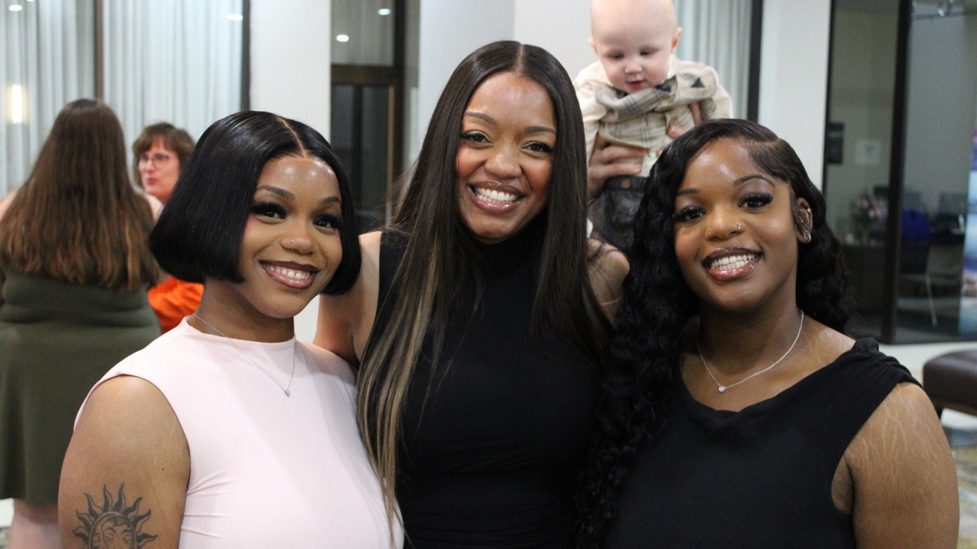 From left to right, P4 students Nicole Nwachukwu, Ashanté Concepcion and Stephanie Nwachukwu pose for a photo, unaware of the cute photobomb happening behind them.