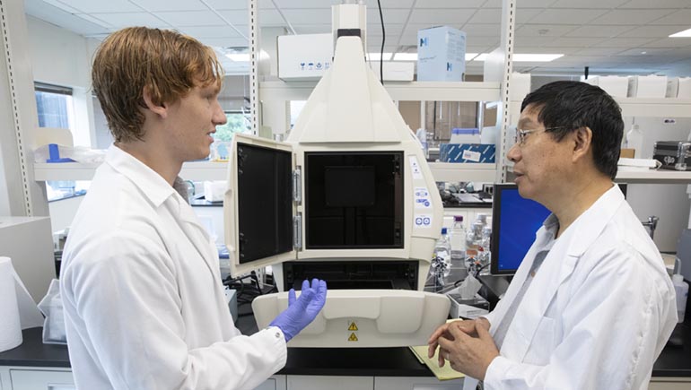 Student Ben Everhart works with Department of Biomedical Engineering chair Kaiming Ye at his laboratory in the Biotechnology Building at the Innovative Technologies Complex.