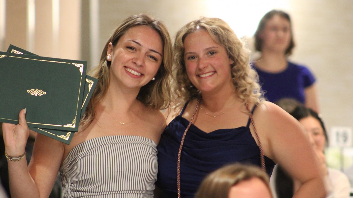 P4 students Calixta Terrell (left) and Bridgette Falco (right) are all smiles after being honored with several awards during the ceremony Wednesday night.