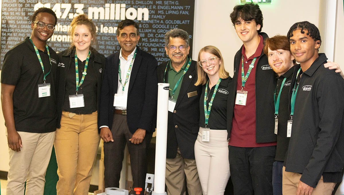 Subhachandra Chandra, MS ’95, and Watson College Dean Atul Kelkar meet with members of the Binghamton University Rover Team at Homecoming 2024.