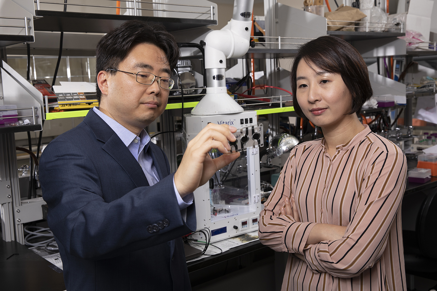 Seokheun (Sean) Choi, associate professor of electrical and computer engineering and Ahyeon Koh, assistant professor of biomedical engineering, work at Choi's lab at the Engineering and Science Building in the Innovative Technologies Complex at Binghamton University's Watson School of Engineering and Applied Science.
