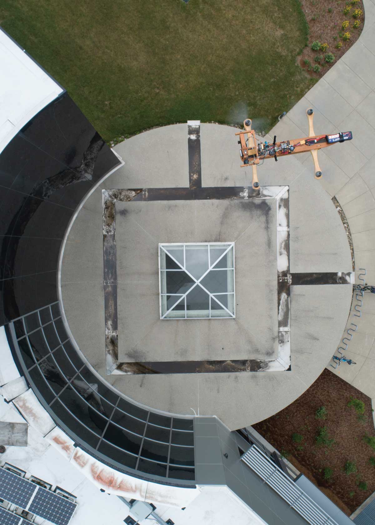 A drone flies above the rotunda at the entrance to the Engineering and Science Building.