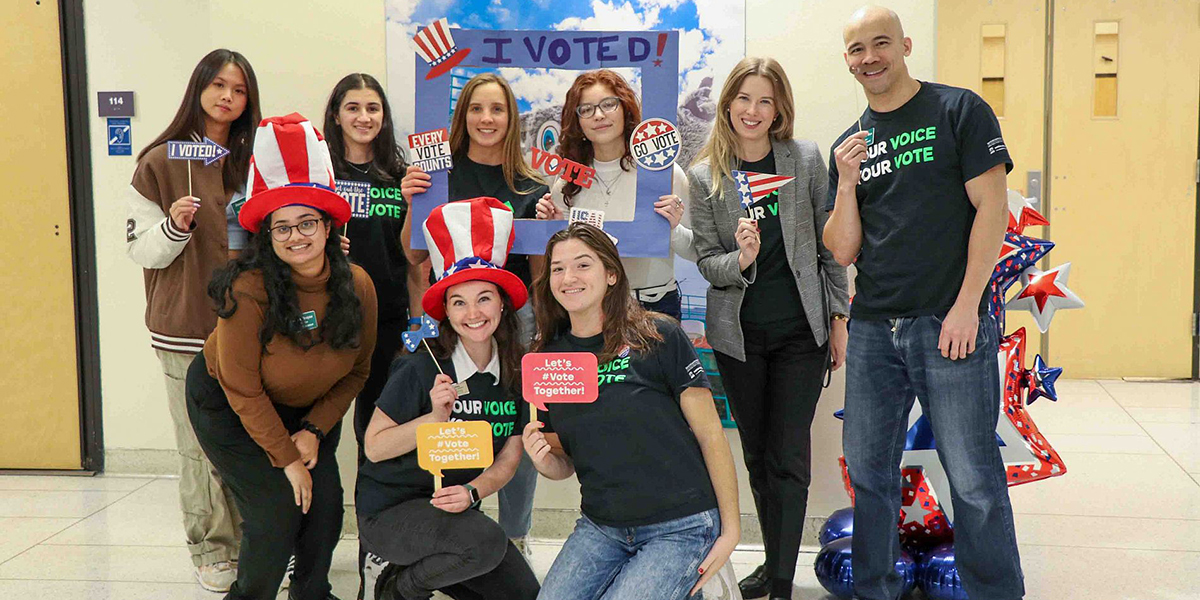 Members of the Center for Civic Engagement staff join with students who worked to increase student voter participation, earning the 2022 ALL IN Campus Democracy Challenge's Most Engaged Campuses for College Student Voting recognition.