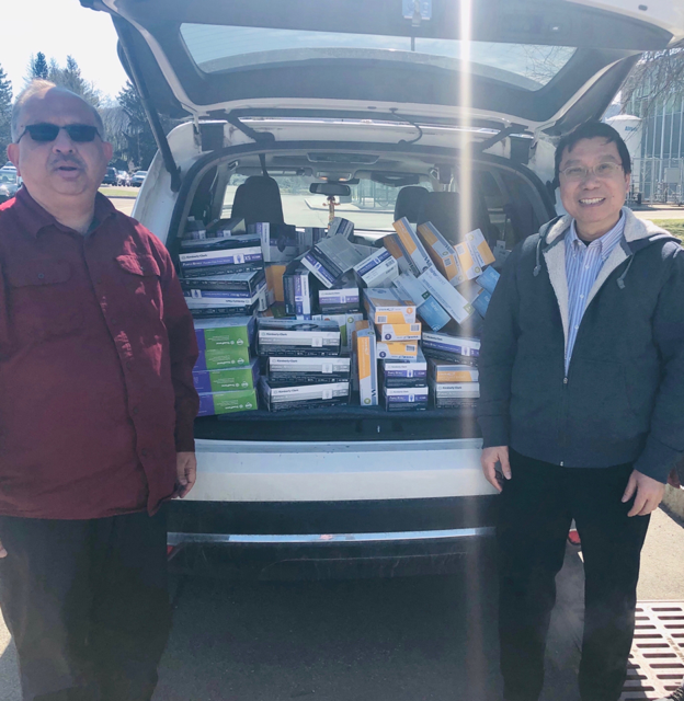 Watson School Dean Krishaswami “Hari” Srihari, left, and Biomedical Engineering Chair Kaiming Ye deliver a donation of medical supplies to UHS.