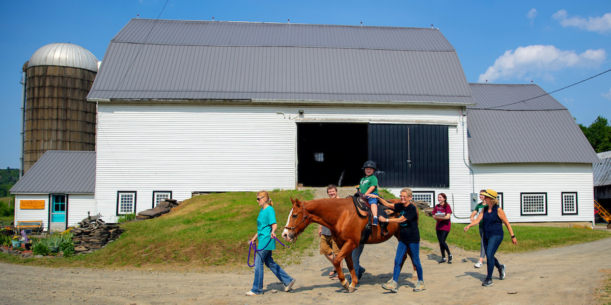 A team of volunteers, horse specialists and Binghamton University speech and language therapists use equine activities at Kali's Klubhouse to provide speech and language therapy to kids like 7-year-old Daniel Carpenter, riding Socks.