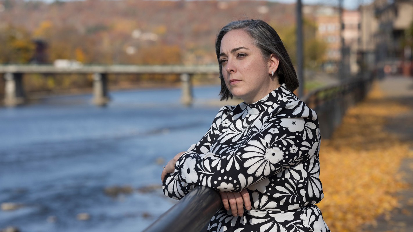 Jackie McGinley looking across the Chenango River in downtown Binghamton.