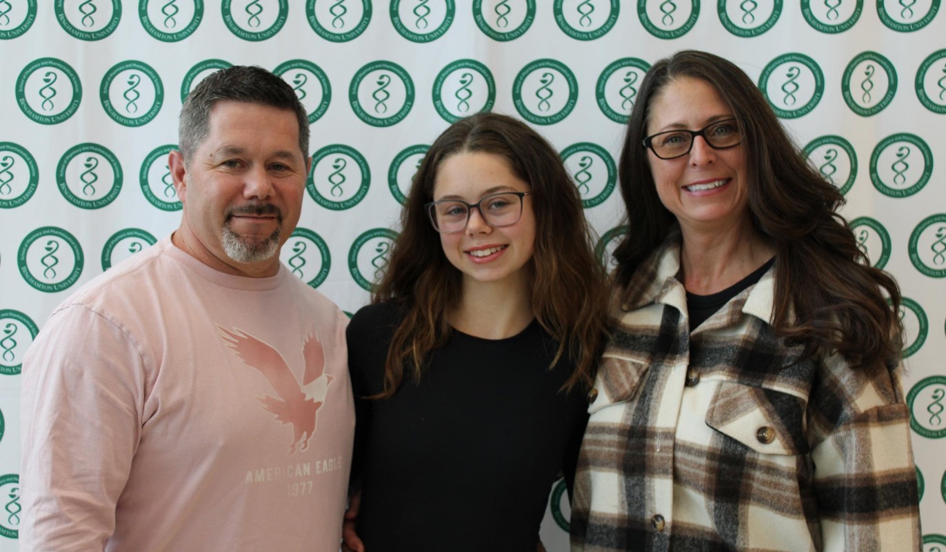 Pharmacy Technician Program graduate Jada Williams (center) with her parents following graduation at the School of Pharmacy.