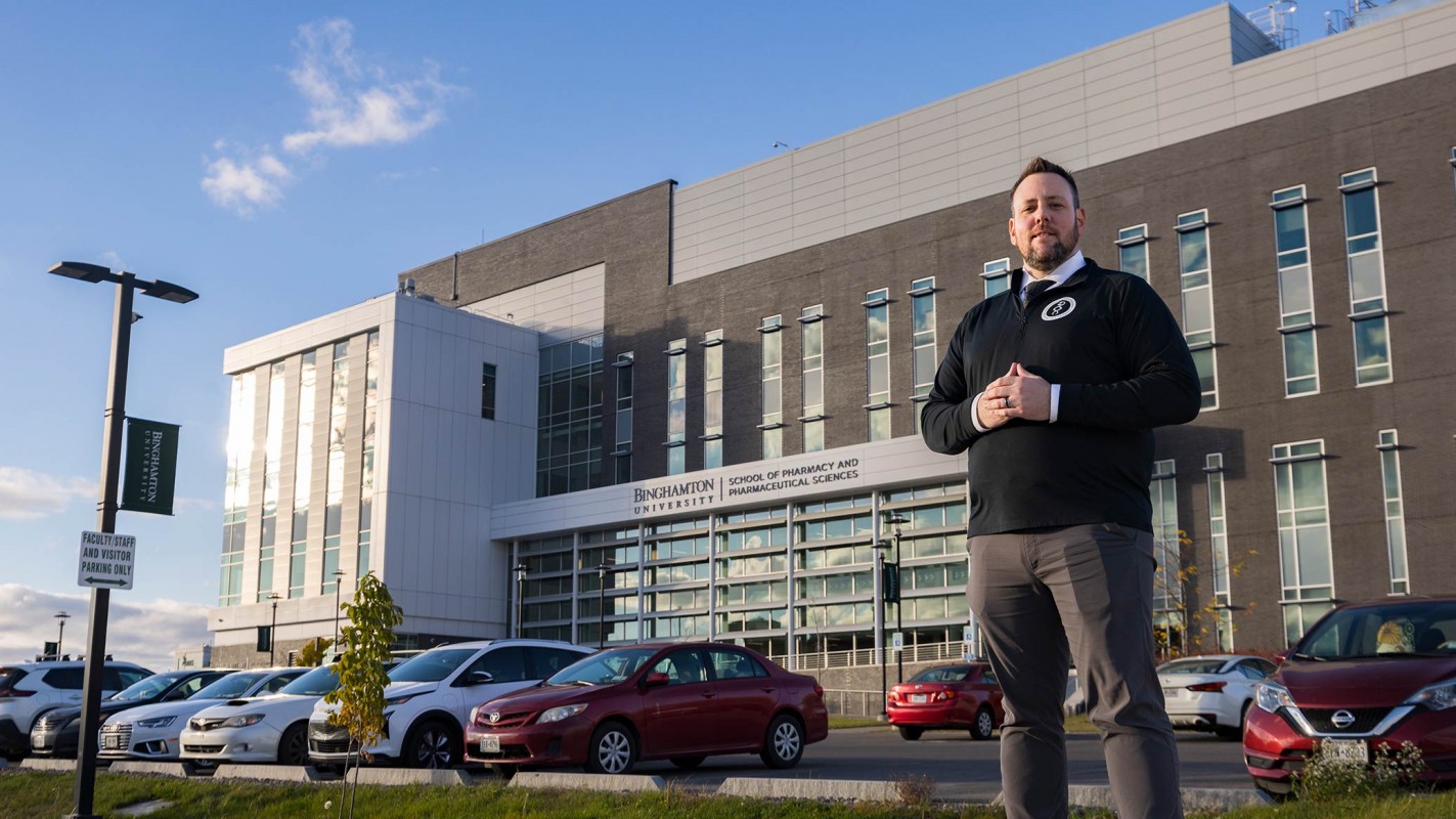 James “JJ” Brice, director of student affairs, in front of the School of Pharmacy and Pharmaceutical Sciences.