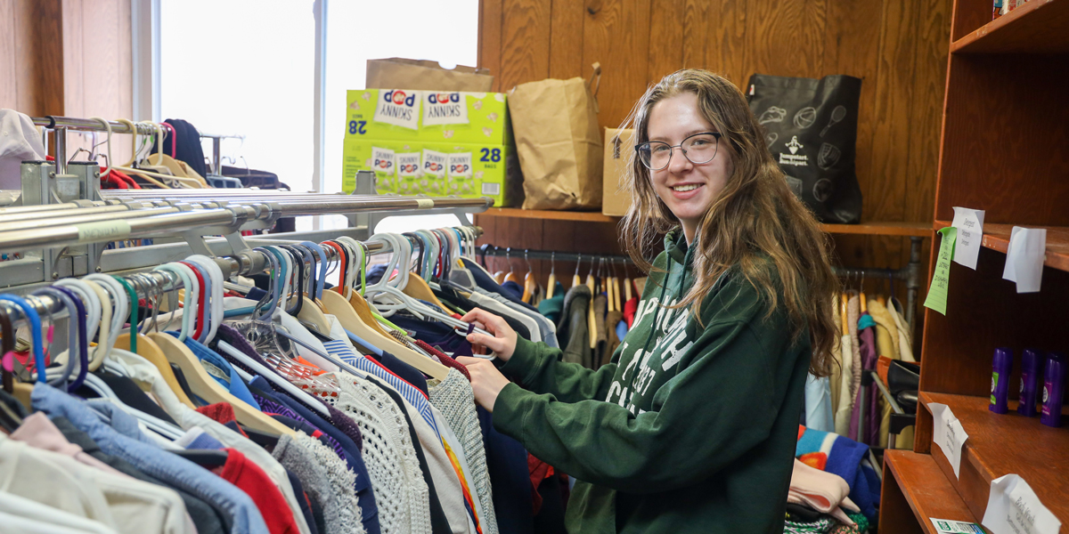 Sophomore Katie Prystalski works in the clothing closet at the North of Main (NoMa) Community Center in Binghamton.