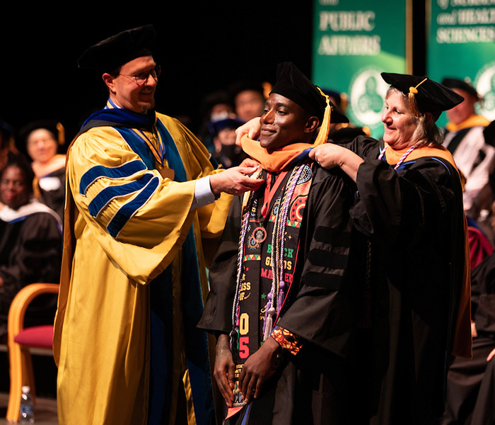 Associate Professor of Nursing Judith Quaranta hoods J'Adore Larosa-Mattis at Binghamton's Doctoral Hooding Ceremony. Larosa-Mattis earned a Doctor of Nursing Practice degree.