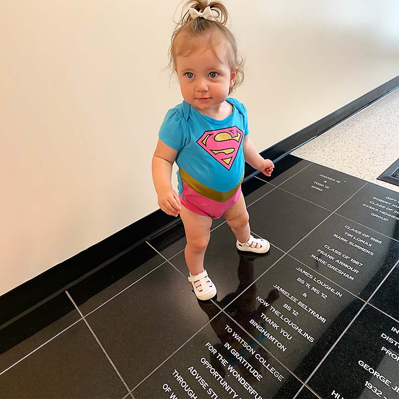 Daughter Madison checks out the tile donation from her parents, James Loughlin ’11, MS ’12, and Jaimelee Beltrami ’12.