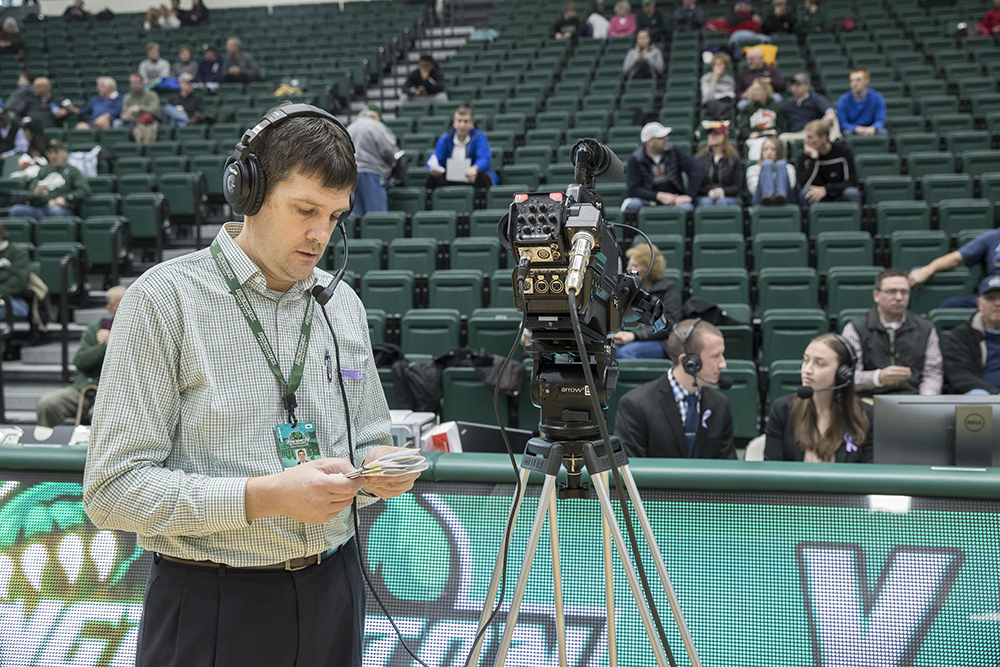 Senior Associate Athletic Director Dennis Kalina, who oversees the broadcasts, helps out on one of the cameras during an early season game.