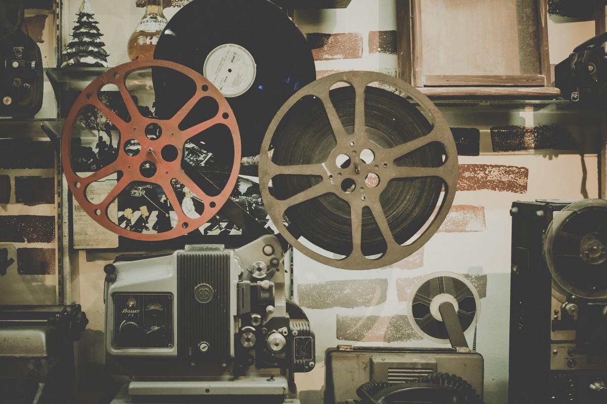 An illustration of film reel and projector equipment.