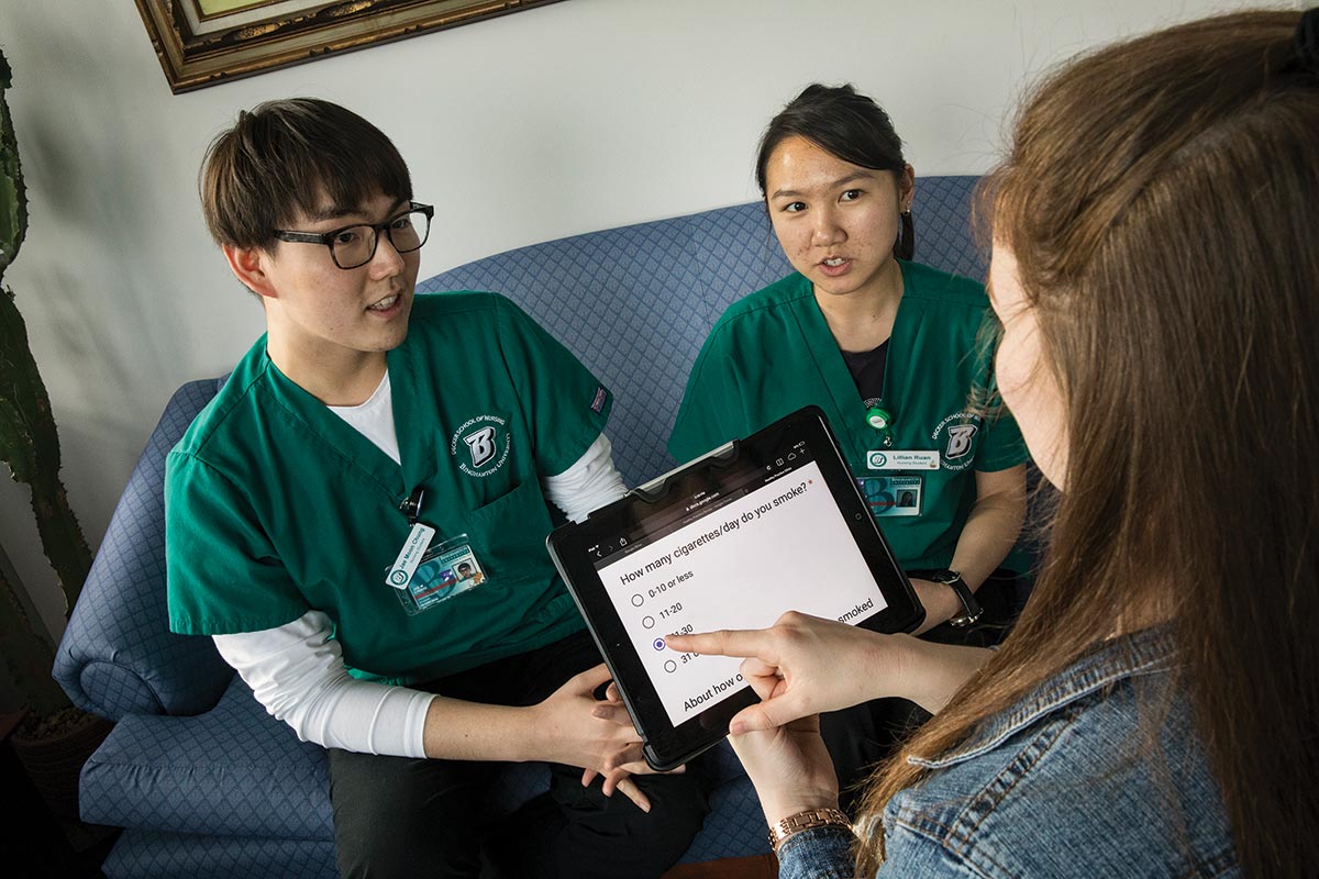 Nursing students Jae Moon Chung, left, and Lillian Ruan interview a mock patient as they prepare for the opening of a tobacco-use support clinic.