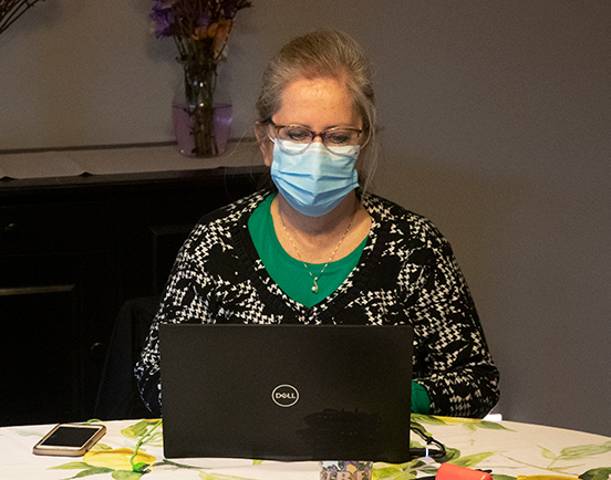 Deborah Palmer, clinical instructor of nursing, observes a student during a home care simulation. Palmer said past experience with home care helped her and co-coordinator Jodi Sutherland enhance the simulation and make it as realistic as possible.