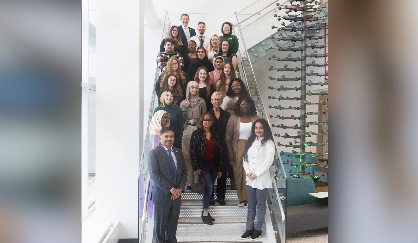 The 2024 inaugural class of the Pharmacy Technician Program poses for a class photo in the School of Pharmacy's atrium along with Dean Nagaraju, faculty and staff members.
